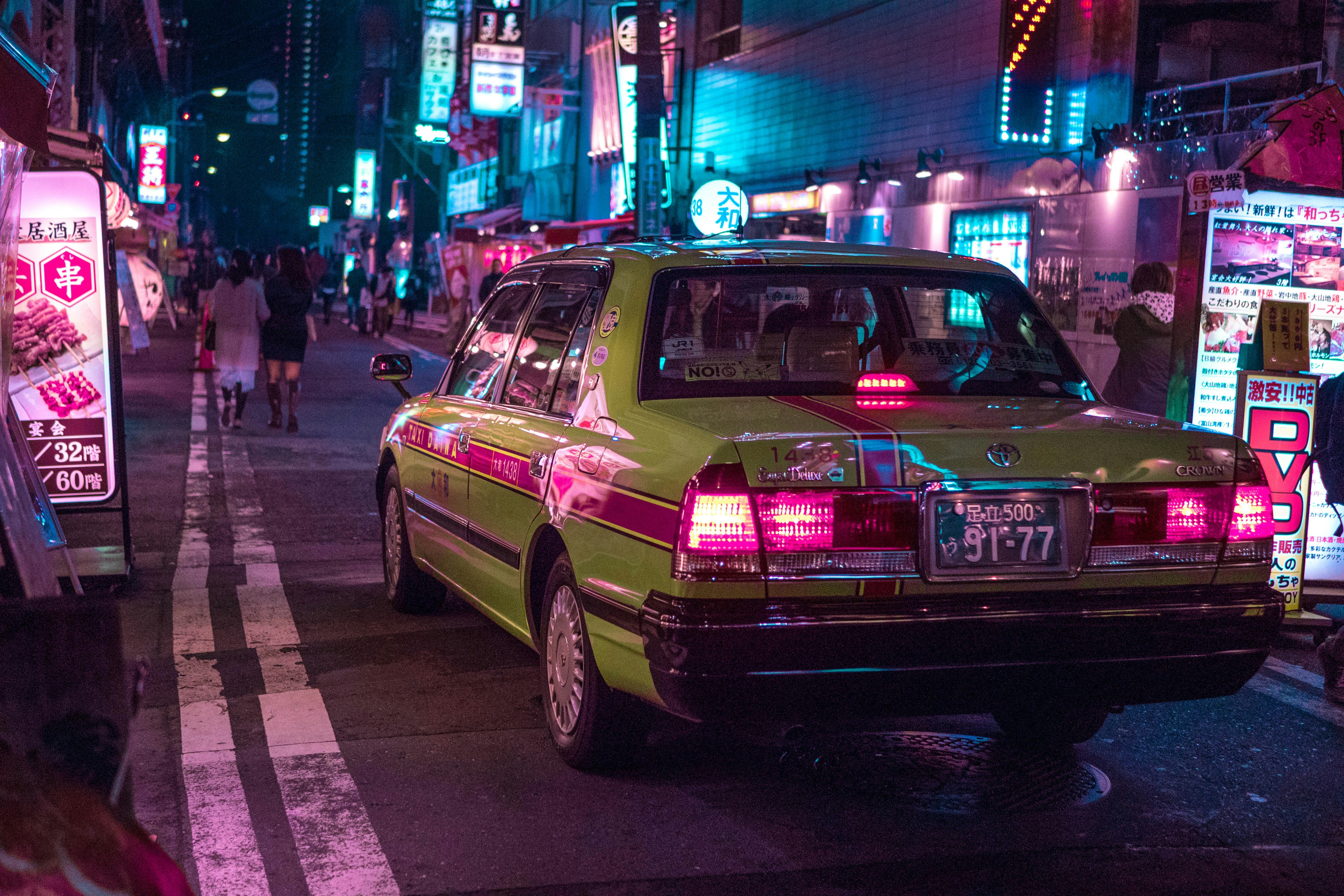 pink sedan on road during night time